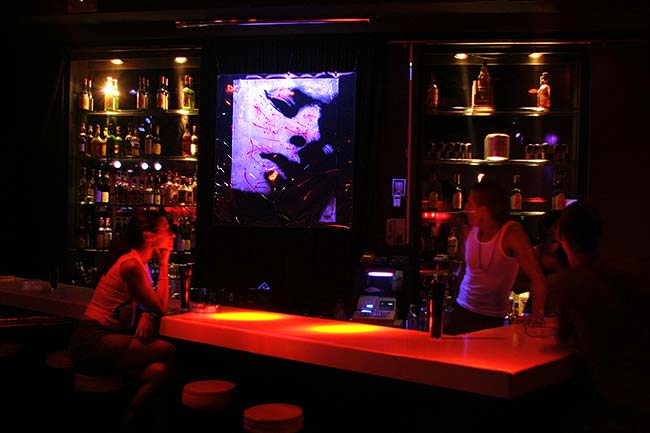 Bar decoration with a glowing artwork showing a female portrait